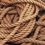 Detailed close-up view of intertwined brown ropes used as ship accessories.