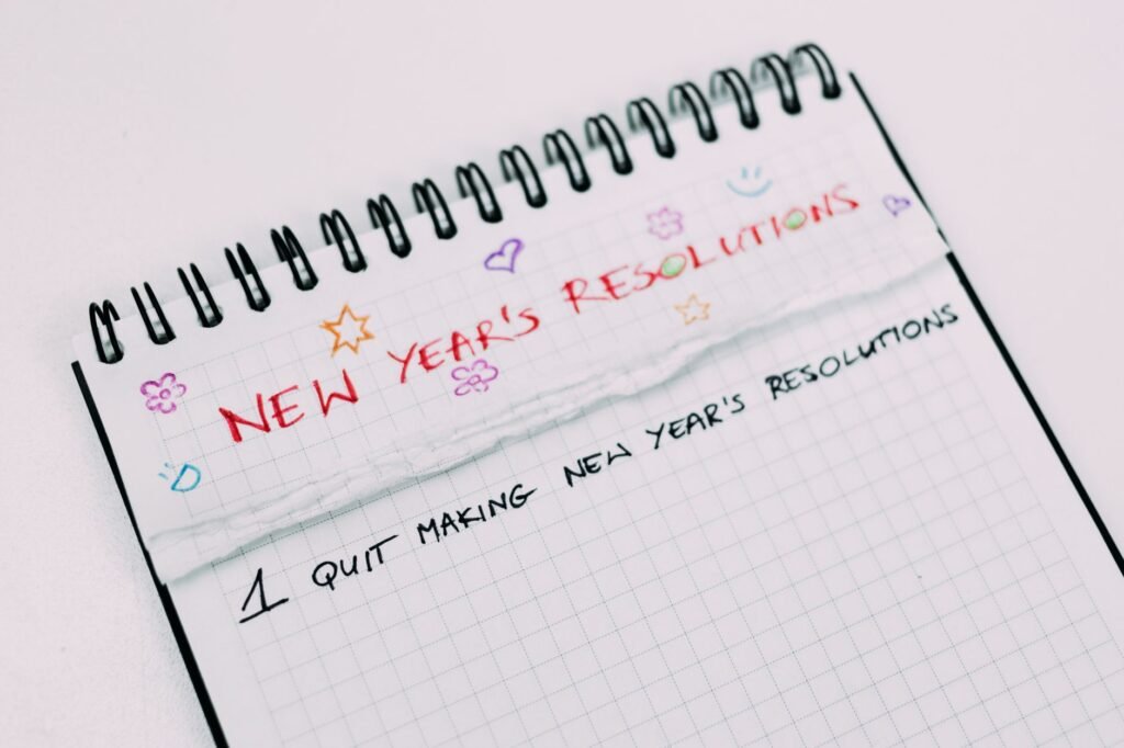 A notebook page with handwritten New Year's resolutions in colorful text.