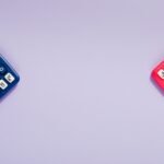 Two colorful calculators on a purple surface, offering ample copy space.