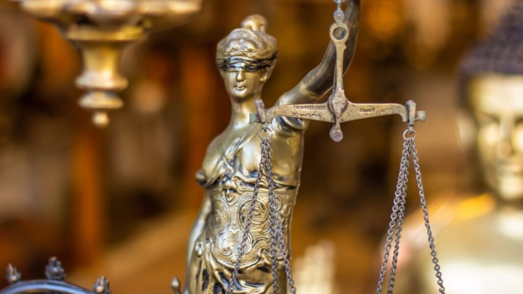A detailed close-up of a Lady Justice statue holding scales, symbolizing law and justice.