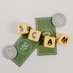 Yellow dice spelling 'Scam' on fake currency, representing financial deception.
