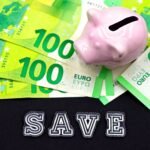 A piggy bank on euro bills with 'save' text highlights money saving concepts.
