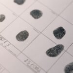 Detailed fingerprints on official document, highlighting identity verification process.