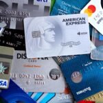 Close-up image of various credit and debit cards including Visa, MasterCard, American Express, and Discover.