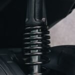 Detailed view of a motorcycle's suspension spring and metal components