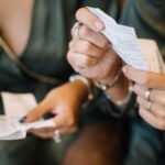 Two individuals reviewing receipts in a close-up scene, focusing on payment details.