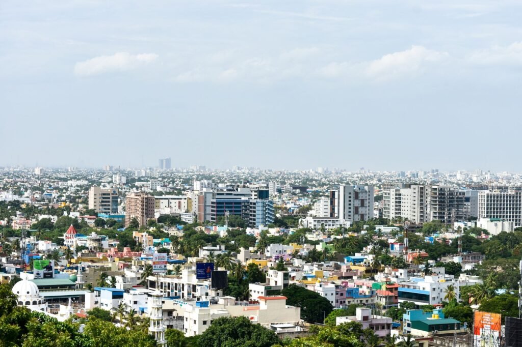 Aerial view of colorful high-rise buildings in Chennai, India, under a clear sky.