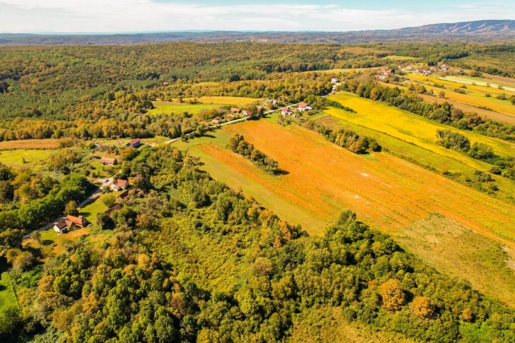 Aerial photo of vibrant countryside in Garešnica, Croatia, showcasing lush farmlands and forests.