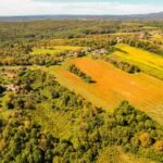 Aerial photo of vibrant countryside in Garešnica, Croatia, showcasing lush farmlands and forests.