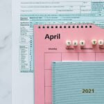 April calendar with tax forms, highlighting tax time reminders for financial tasks.