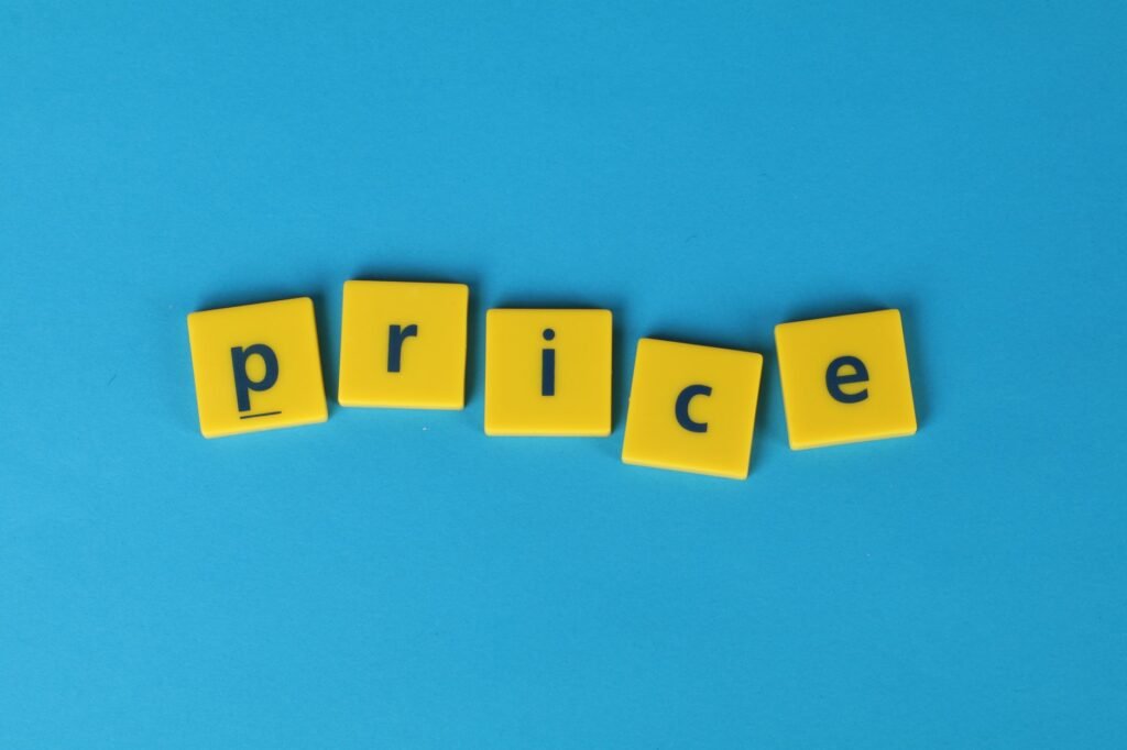 Yellow letter tiles spell the word 'price' against a vibrant blue backdrop, ideal for business concepts.