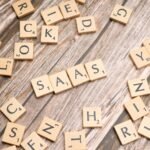 Wooden letter tiles spelling SaaS on rustic wood. Ideal for cloud computing and business concepts.