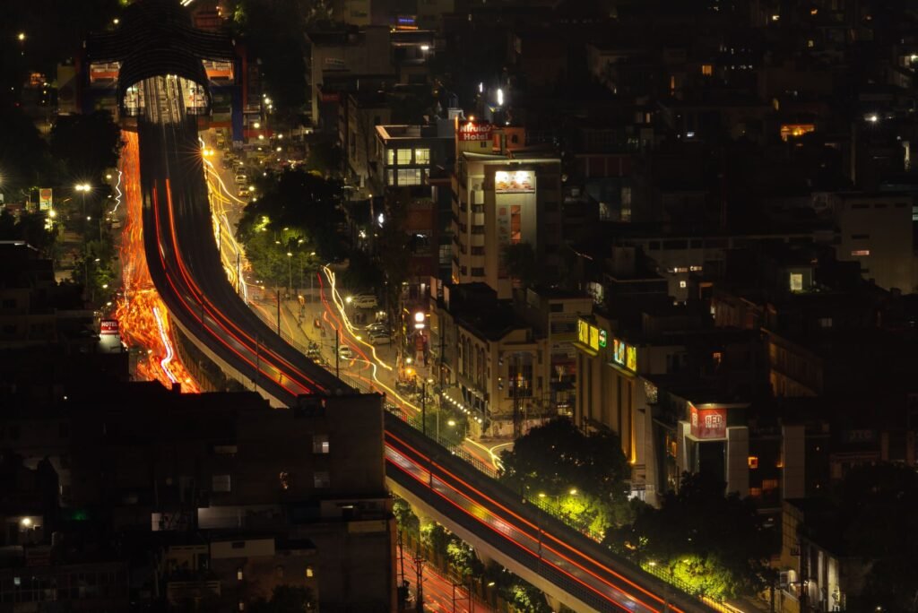 Long exposure cityscape of vibrant Delhi streets at night.