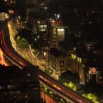 Long exposure cityscape of vibrant Delhi streets at night.