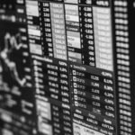 Monochrome image of stock market data on a screen, depicting financial information and trends.