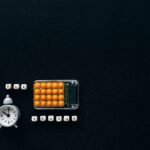 Flat lay of a tax season theme with a clock and calculator on a dark background.