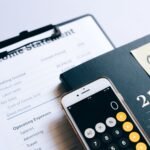 Close-up of income statement, calculator, and planner for financial planning.