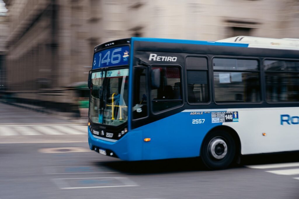 Blue public bus moving through the streets of Buenos Aires, Argentina.