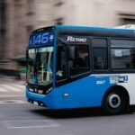 Blue public bus moving through the streets of Buenos Aires, Argentina.