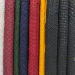 A close-up view of colorful textured fabric rolls showcasing intricate patterns.