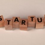Wooden blocks forming the word 'STARTUP' on a neutral background, symbolizing new business ventures.