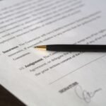 Close-up image of a business contract and pen, signed and ready for agreement.