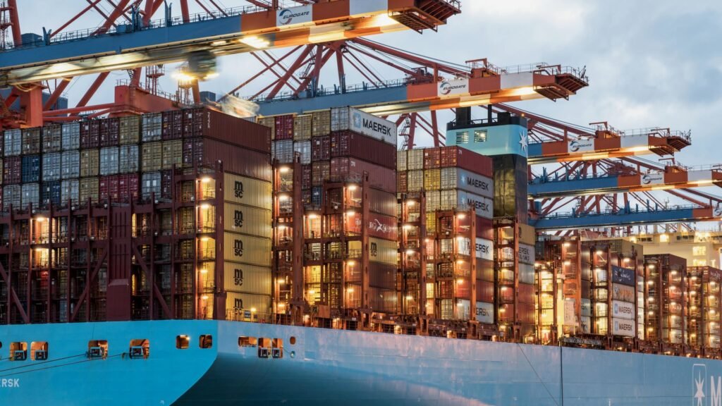 A vibrant cargo ship loaded with containers at Hamburg harbor, showcasing maritime industry.