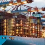 A vibrant cargo ship loaded with containers at Hamburg harbor, showcasing maritime industry.