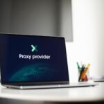 Laptop screen showing 'Proxy provider' in a tech office setting, focus on cybersecurity.