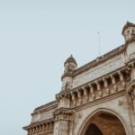 Low-angle view of the Gateway of India showcasing intricate architectural design in Mumbai.