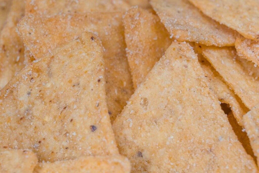 A macro view of crunchy, salted corn chips, perfect snack delicacy.