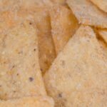 A macro view of crunchy, salted corn chips, perfect snack delicacy.