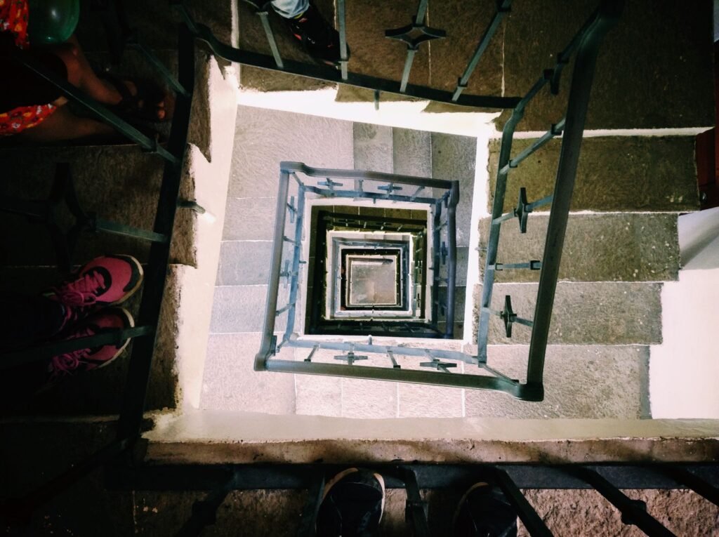 Looking down a spiral staircase in Ciudad de Chiautla, Puebla with visible railings and steps.