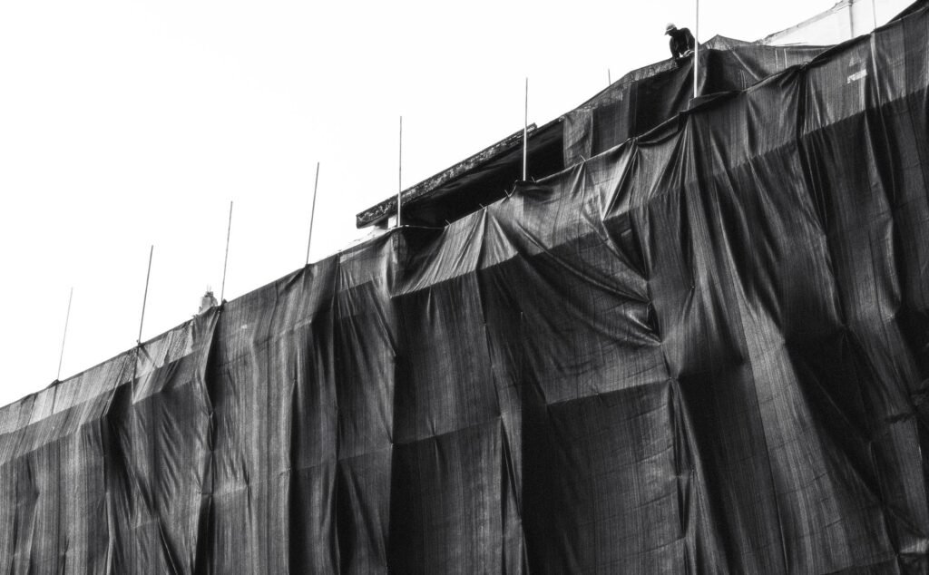 Black and white image of a construction site covered with protective sheeting in Vietnam.