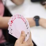 Close-up of a person holding a fan of playing cards, perfect for game or poker-related visuals.