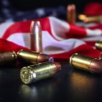 Close-up of brass bullets on American flag, symbolizing freedom and force.