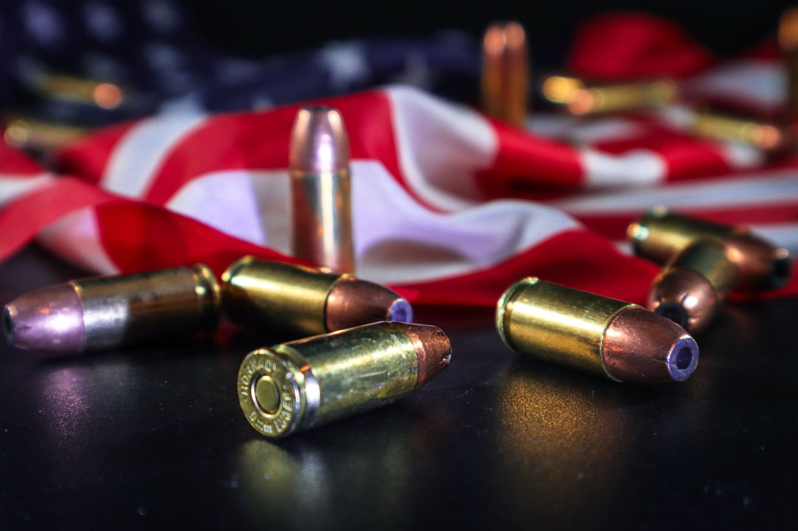 Close-up of brass bullets on American flag, symbolizing freedom and force.