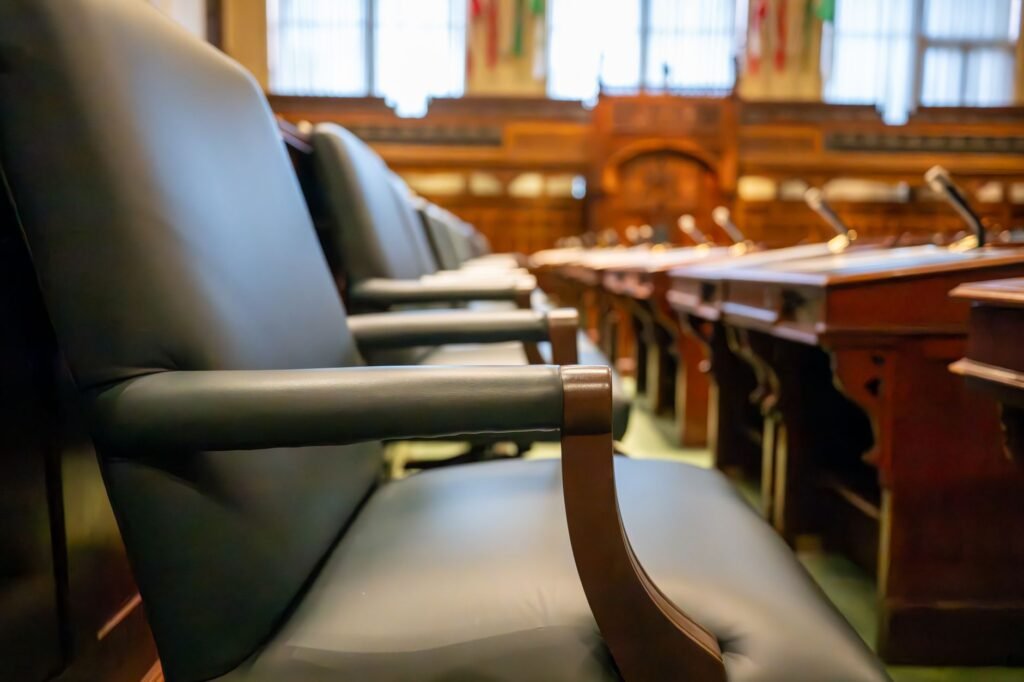 Elegant courtroom seating with leather chairs and wooden desks, exuding a sense of authority.