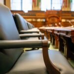 Elegant courtroom seating with leather chairs and wooden desks, exuding a sense of authority.