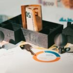 Euro notes with house model and financial charts symbolize real estate investment and economic growth.