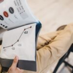 Close-up of a man reviewing business growth charts and statistics in an office setting.