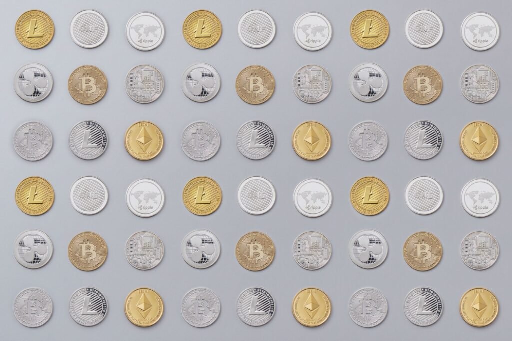 A seamless pattern of various cryptocurrency coins in gold and silver tones.
