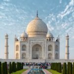 Explore the iconic Taj Mahal, a UNESCO World Heritage Site in Agra, India, captured under a bright blue sky.