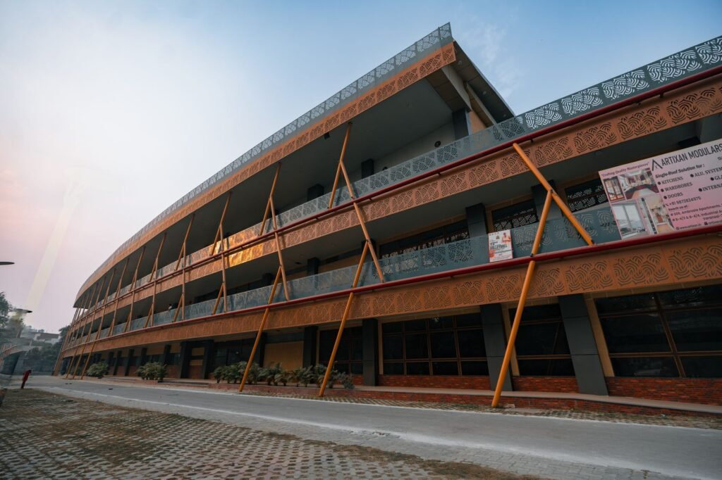 Contemporary architecture of a school building in Delhi, India, captured at dusk with ornate designs.