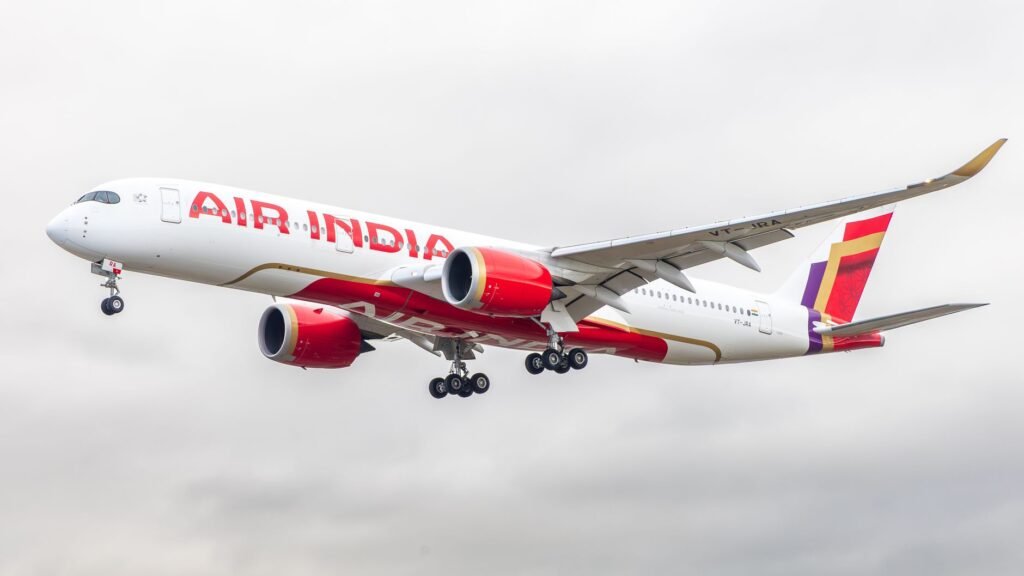 Air India Airbus A350 landing at an airport in England against a cloudy sky.