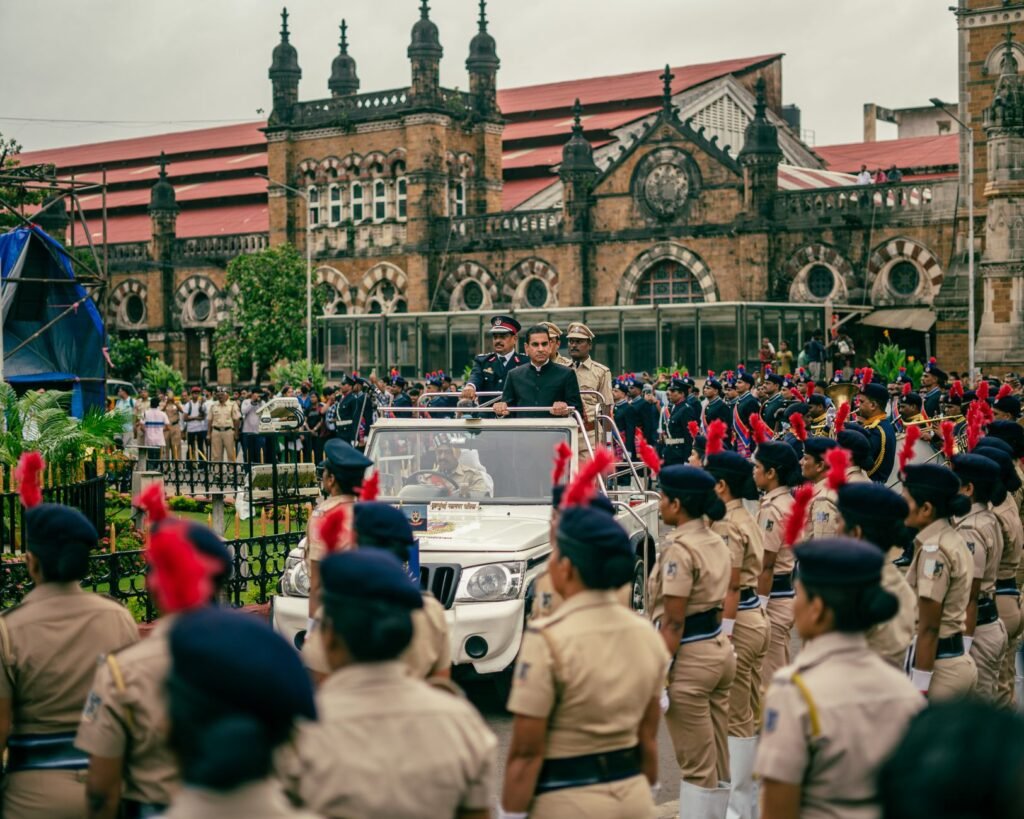 Vibrant parade with police officers celebrating Independence Day in Mumbai, India, near Chhatrapati Shivaji Terminus.