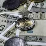 Detailed view of Indian rupee banknotes and coins, showcasing currency and finance concepts.