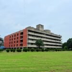 Concrete BR Ambedkar Administrative Building nestled in green garden, Chandigarh.