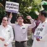 A group of men holding signs in an outdoor political protest.