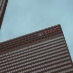 Modern skyscraper featuring the UBS logo against a clear sky in New York City.